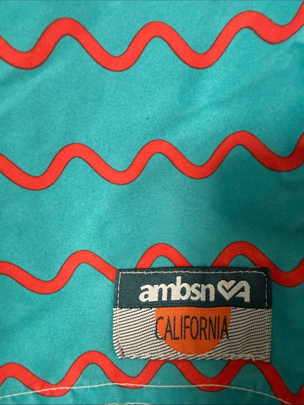 Men's Turquoise Swim Trunks with Red Wave Pattern